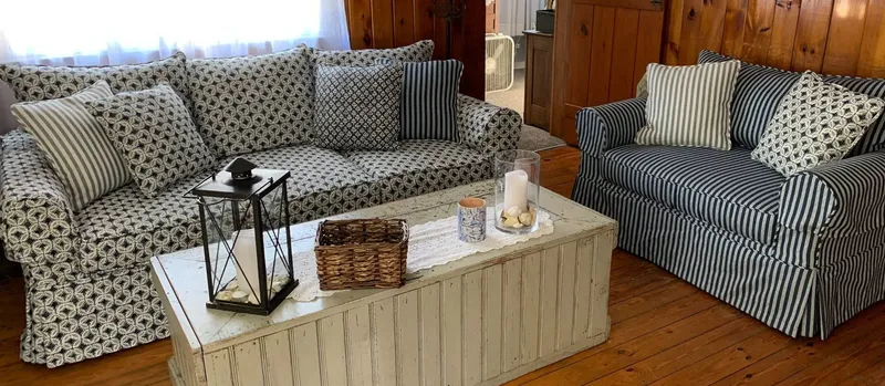 Custom tailored crisp linen slipcover on a sofa and armchair in Truro, MA